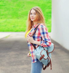 Portrait young girl wearing a shirt with backpack outdoors in ci