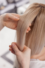 Professional hairstylist is working at beauty salon