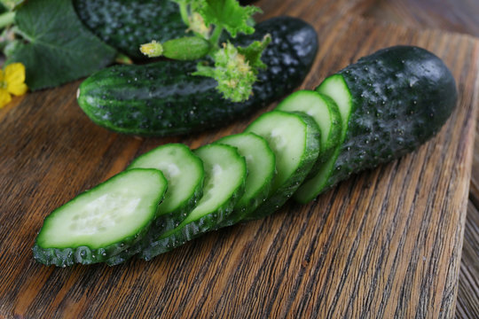 Cucumbers on wooden background, close up