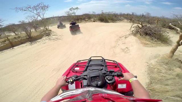 First person POV of a group of people on four wheelers taking off 