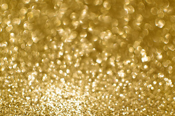 Gold glittering christmas lights. Blurred abstract background