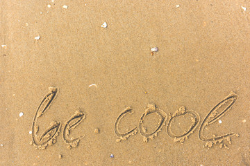 Be cool written on the beach sand
