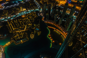 Dubai downtown night scene with city lights. Top view