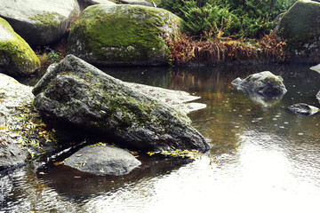 Lake with stoned shores in the autumn park