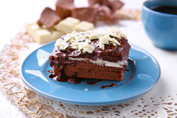 Delicious chocolate brownie on plate on wooden background