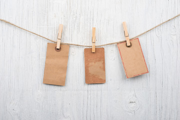 Labels on clothesline on retro wooden background and space for text