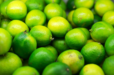 Lots of bright green limes in supermarket.
