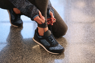 Sports woman legs in sneakers on stairs