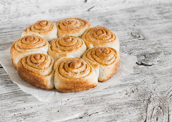 cinnamon rolls on bright wooden surface