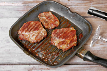 Roasted beef fillet on pan, on wooden background