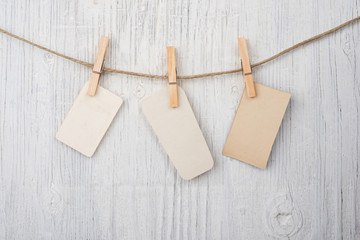 Labels on clothesline on retro wooden background and space for text