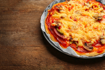 Delicious pizza with vegetables, on wooden table