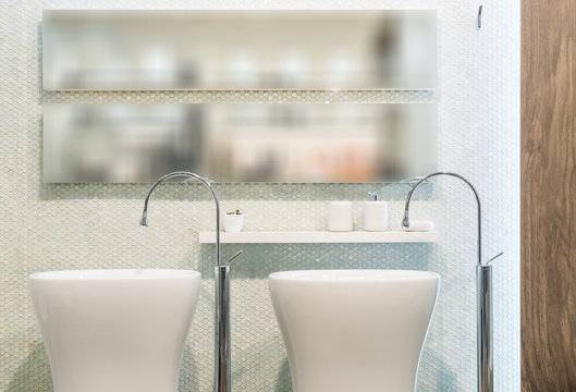 Washbasin and mirror in modern bathroom interior