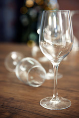 Empty wine glasses on wooden table against blurred background