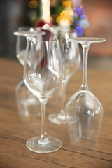 Construction of empty wine glasses on wooden table against blurred background