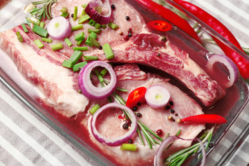 Marinating meat with spices on table, close up