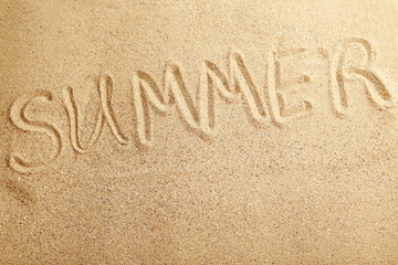 Summer handwritten in a beach sand