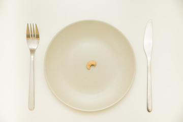 Cashew on plate with fork and knife