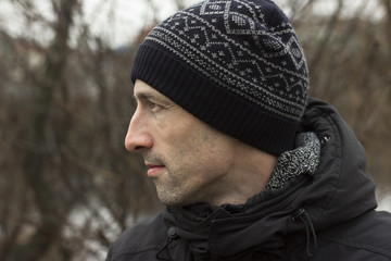 A man in a knitted cap and a black jacket