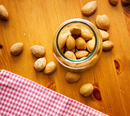 almonds in bowl on wooden table, top view