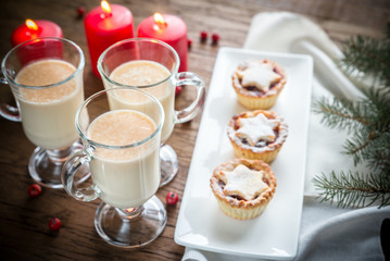 Glasses of eggnog with mince pies