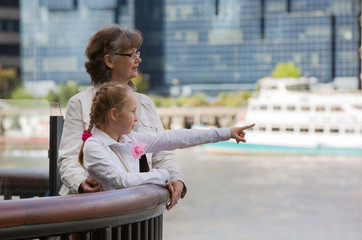 Little girl and grandmother walking through the bridge and enjoying the view City of London