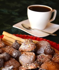Christmas cookies with cup of black coffee decorated on a table