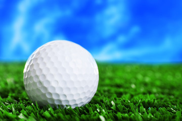 Golf ball on green grass course, close-up