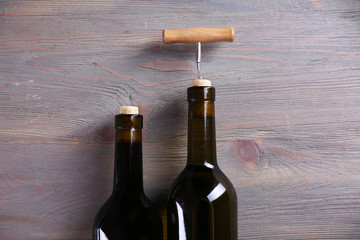 Two bottle wine and corkscrew on purple wooden background