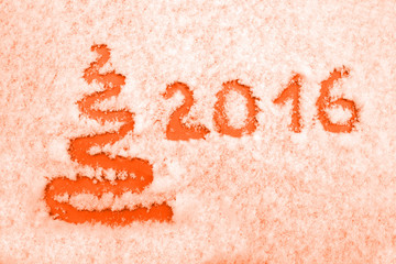 Hand written and abstract xmas tree 2016 on snow. New year and Christmas card coloured in orange.
