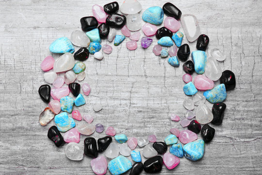 Circle formed frame of minerals on grey scratched background, copy space