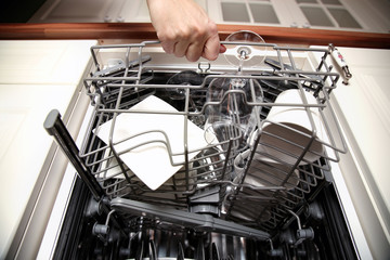 Open dishwasher with clean utensils