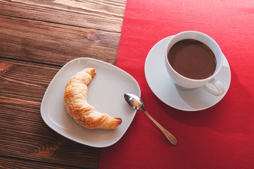 Hot chocolate in a white cup on a wooden table