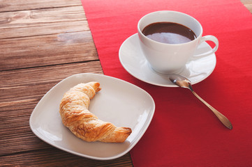 Hot chocolate in a white cup on a wooden table