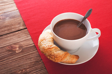 Hot chocolate in a white cup on a wooden table