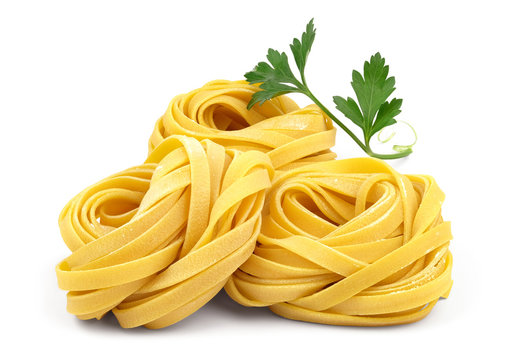 Italian rolled fresh fettuccine pasta with flour and parsley isolated on white background. 