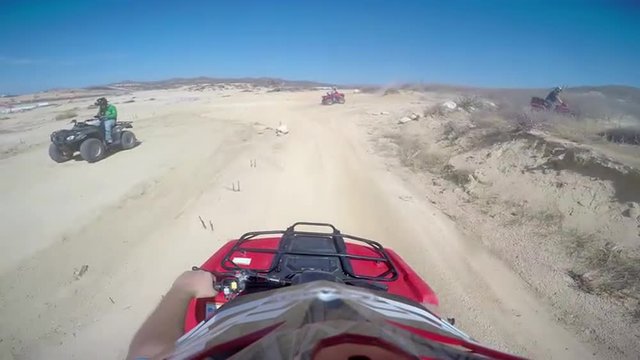 First person POV of a four wheeler driving on trails at the coast