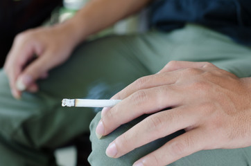 a young man smoking a cigarette