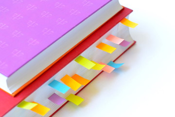 Book with post-it notes/book with colorful post-it notes on white background.