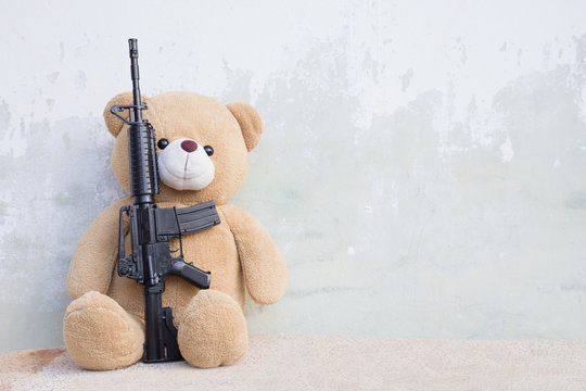 Teddy bear with toy gun
