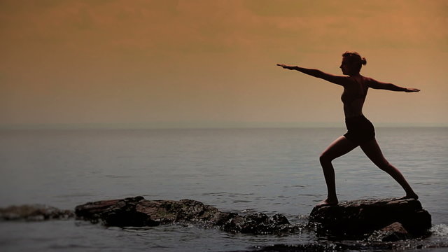 Woman Doing Different Yoga Position in front of the Sea