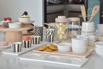 Fototapeta na wymiar Cookies and cupcakes with cute bakeware setting on white top tab