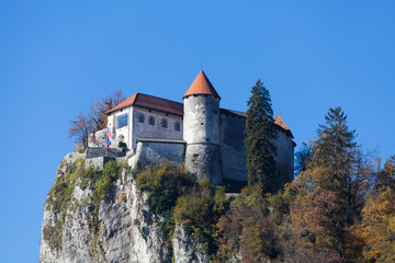 Fototapeta na wymiar Bled Castle built on top of a cliff overlooking lake