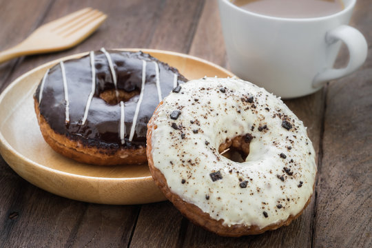 Donuts on wooden plate and coffee cup