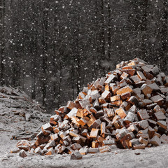 snow falling on warming wood