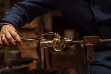 Glass Artist in her workshop making glassware - 97475753