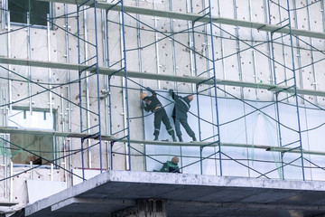 Naklejka premium three builders build the house