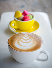 Cup of hot coffee and macaroons