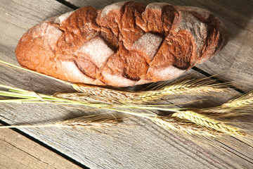 Freshly baked traditional bread on wooden table