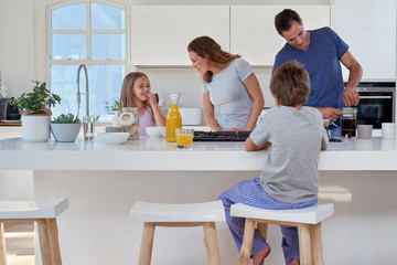 family in kitchen for breakfast